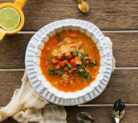 vegan moroccan red lentil soup recipe gluten free, bowl of moroccan red lentil soup with two spoons and a citrus juicer