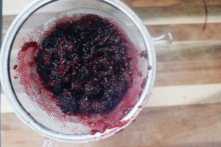 blackberry simple syrup, blackberry simple syrup mixture being put through a fine mesh sieve
