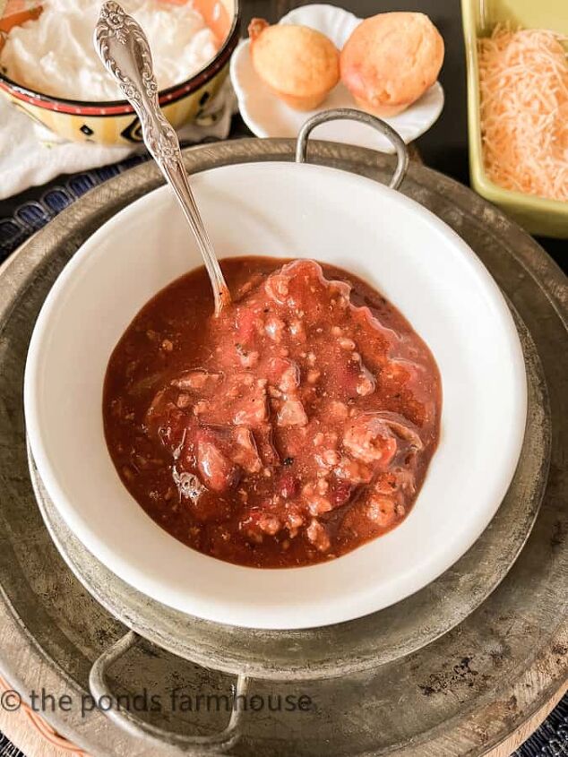 Easy Winter Chili recipe served with sour cream shredded cheese and sweet corn bread muffins