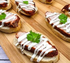spicy pork tenderloin crostini with lime crema, spicy pork tenderloin crostini with lime crema on a wooden platter