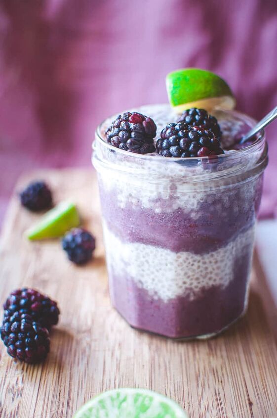 blackberry lime chia seed wellness parfait, a glass filled with purple smoothie layers and chia seed pudding