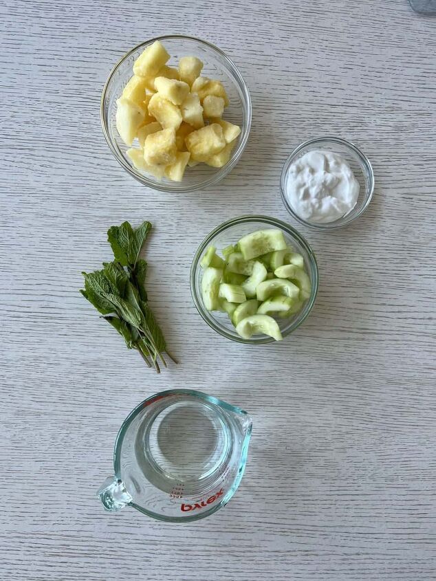 pineapple cucumber smoothie detoxifying and delicious, photo of ingredients for pineapple cucumber smoothie coconut water frozen pineapple chunks cucumber mint and coconut yogurt