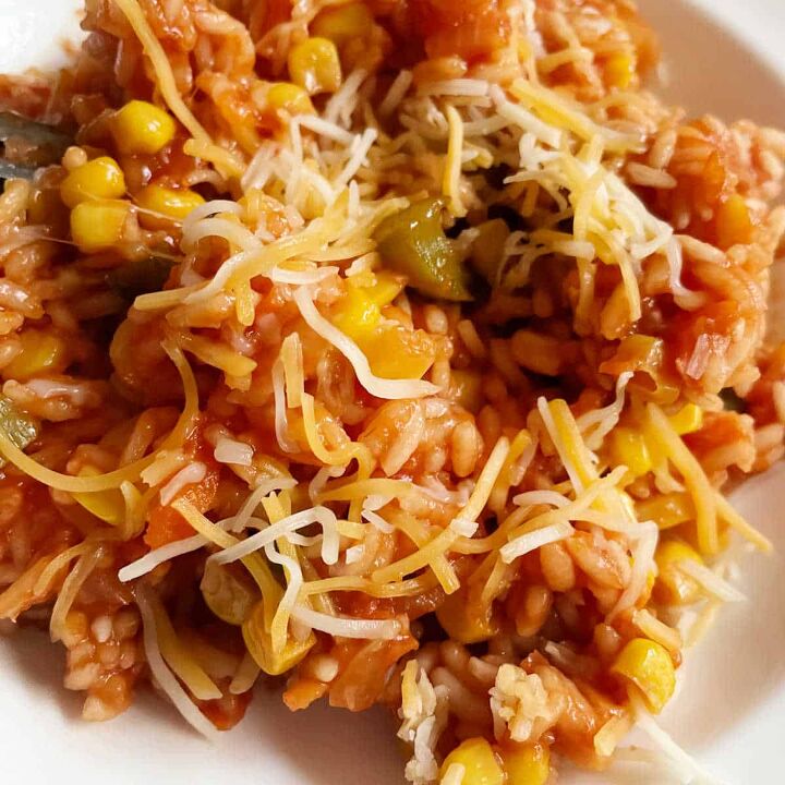 experience the pleasure of cooking authentic mexican rice, Mexican rice close up with cheese sprinkled on top