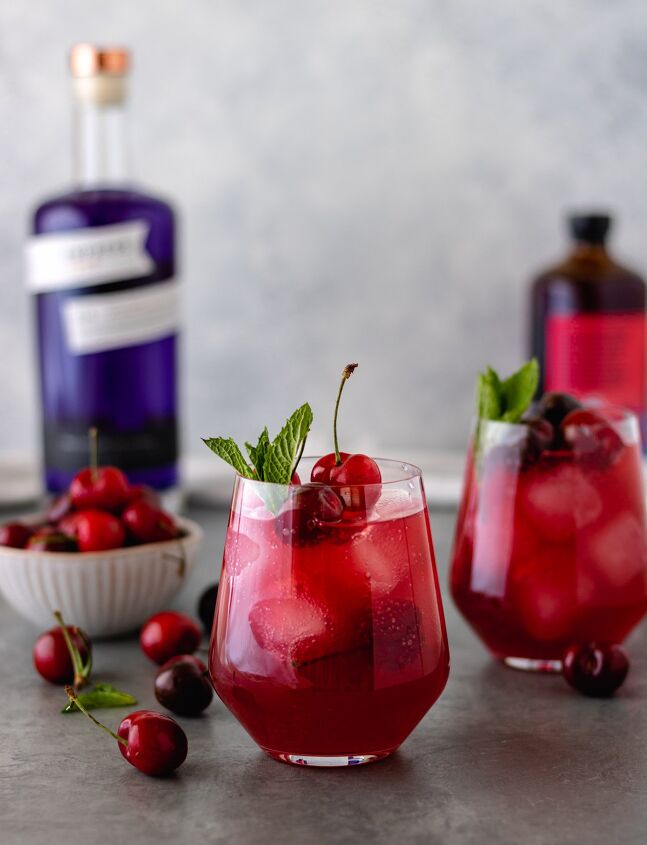 cherry berry gin kombucha cocktail, Two glasses of a Cherry Berry Gin Kombucha Cocktail topped with fresh cherries and fresh mint