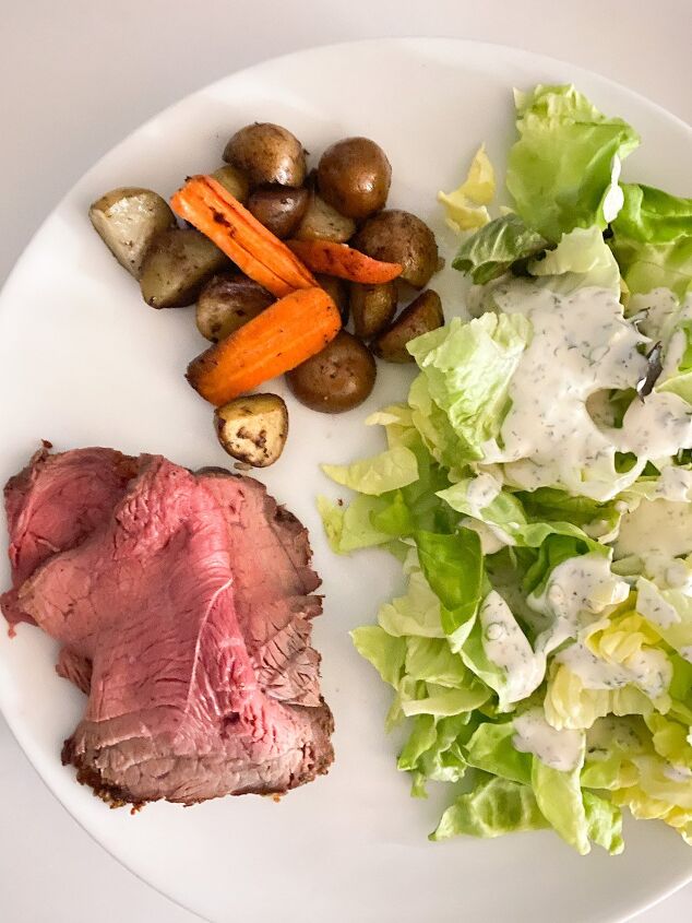 best beef roast with roasted veggies, plate with sliced beef roast roasted vegetables and a side salad