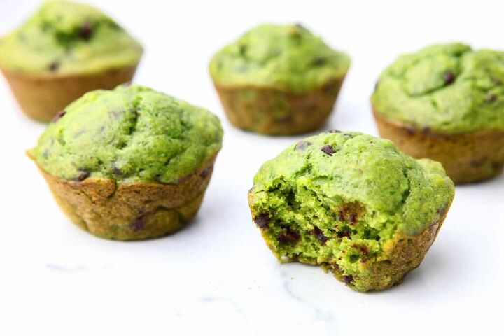 spinach muffins healthy hulk muffins, Five green spinach muffins on a marble counter top with a bite taken out of them