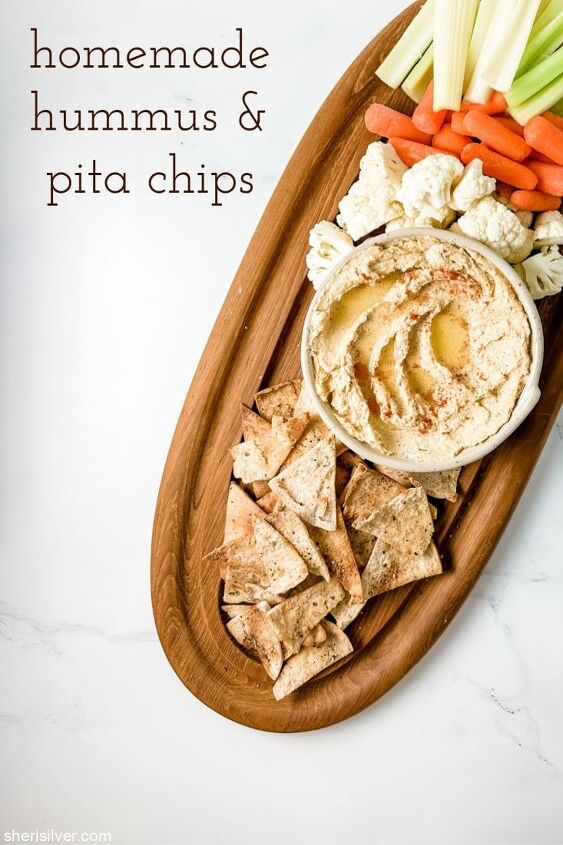 homemade hummus and pita chips sheri silver, hummus on a wooden board with pita chips and crudite