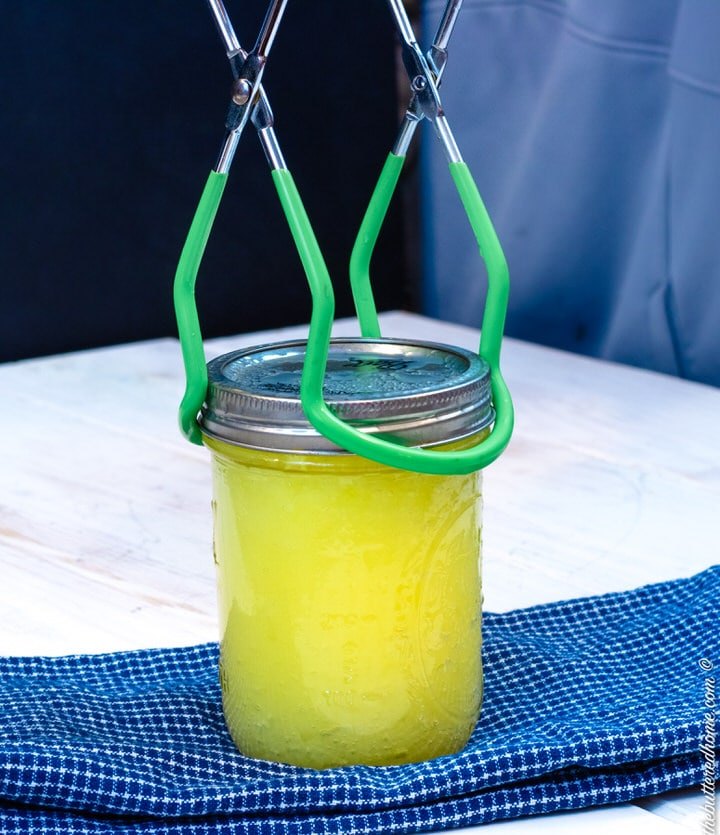 pressure cooker lemon curd, taking lemon curd jar out with tongs
