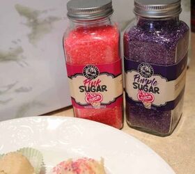 edible sugar cookie dough recipe, the pink and sugar sprinkles glass jars in the background with edible sugar cookie dough in foreground