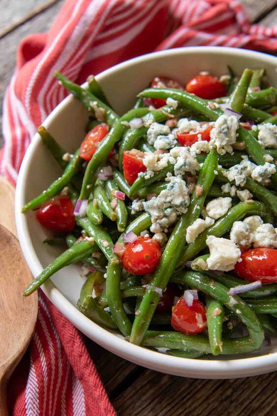 marinated green bean salad, a close up of a serving bowl of beans blue cheese and tomatoes