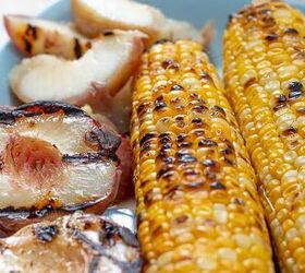 grilled chicken salad, grilled peaches and corn on a blue plate