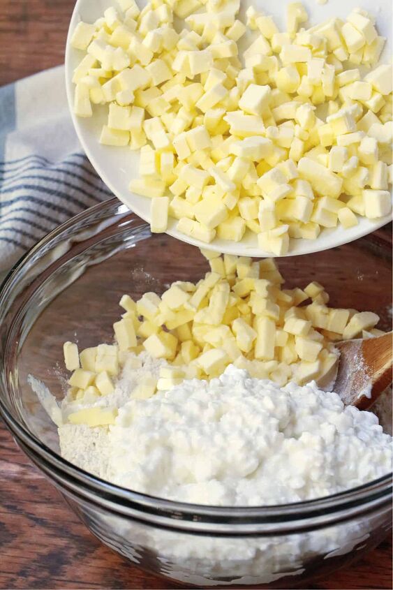 butterhorn recipe with cottage cheese, A clear glass bowl filled with cottage cheese and flour and adding cubed butter