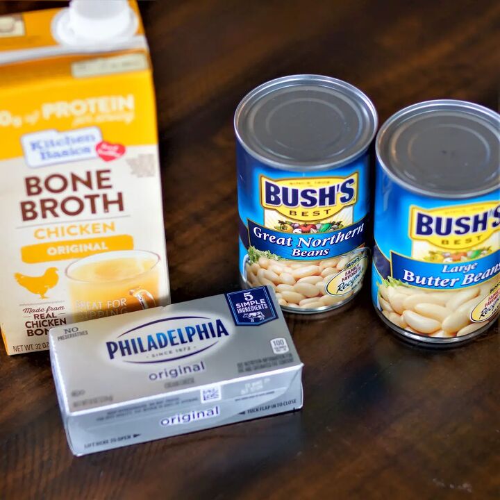 dutch oven white chicken chili, Cans of white beans chicken broth and cream cheese on a table