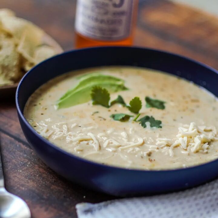 dutch oven white chicken chili, Bowl if rotisserie white chicken chili on a wood table