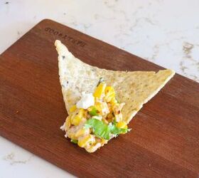 elote dip recipe, Elote dip on tortilla chip on a wooden plate