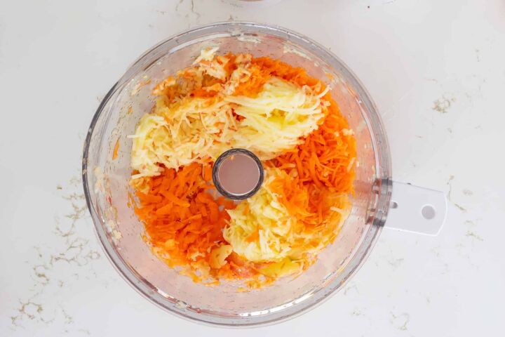 carrot bread recipe, Grated carrot and grated apple in the bowl of a food processor