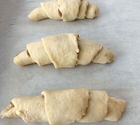 crescent roll cinnamon rolls, Four unbaked crescent rolls on a cookie sheet