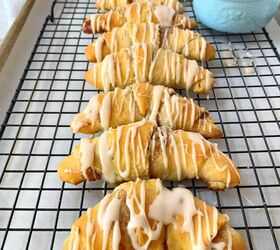 crescent roll cinnamon rolls, A cooling rack with crescent rolls on top and a bowl of icing