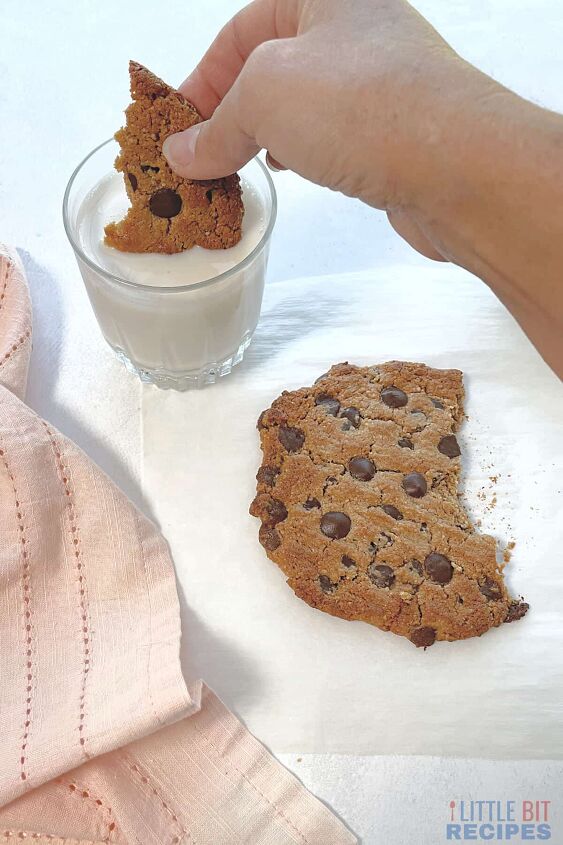 healthy single serve cookie vegan, dipping broken off piece of cookie in glass of milk