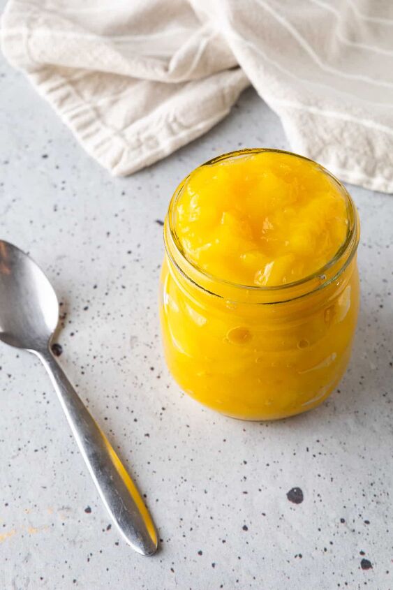 mango compote, A jar of mango compote with a spoon