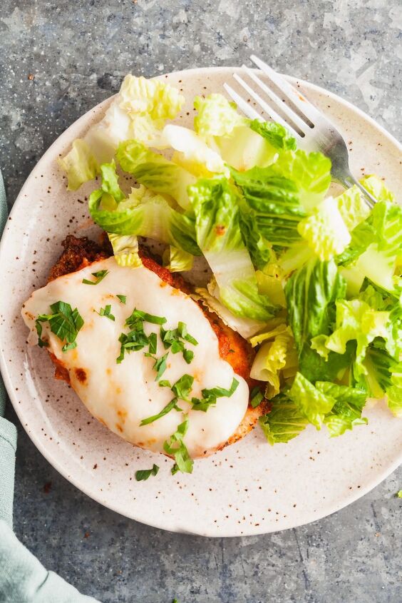 easy air fryer chicken parmesan, Overhead view of chicken parm plated with a green salad