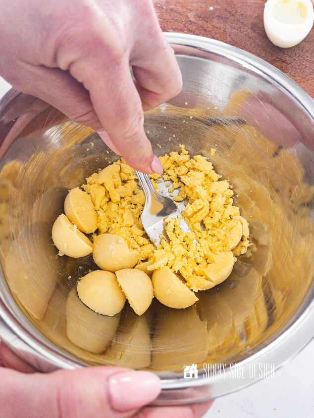 Mash eggs yolks with a fork