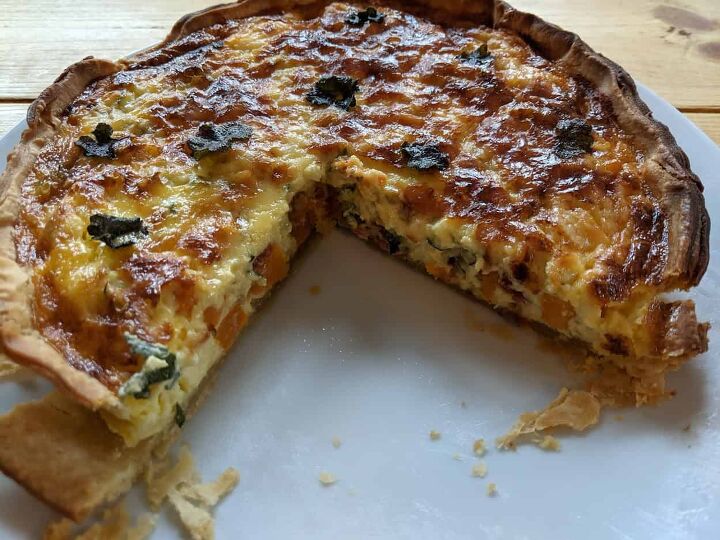 cooked ground ivy butternut squash and bacon quiche with slice taken out