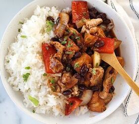 marinated chicken stir fry with pineapple and beans, Brazilian Marinated Chicken Stir Fry with pineapple black beans red Pepper and onions in a bowl over white rice with a bamboo fork and cilantro garnish It is truly one amazing dish with incredible flavor