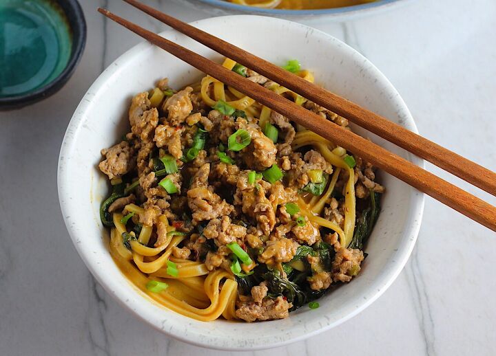 ground chicken dan dan noodles easy recipe, Dan Dan Noodle Recipe with Ground Chicken in a bowl Chopsticks are sitting on top and scallion slices are on top