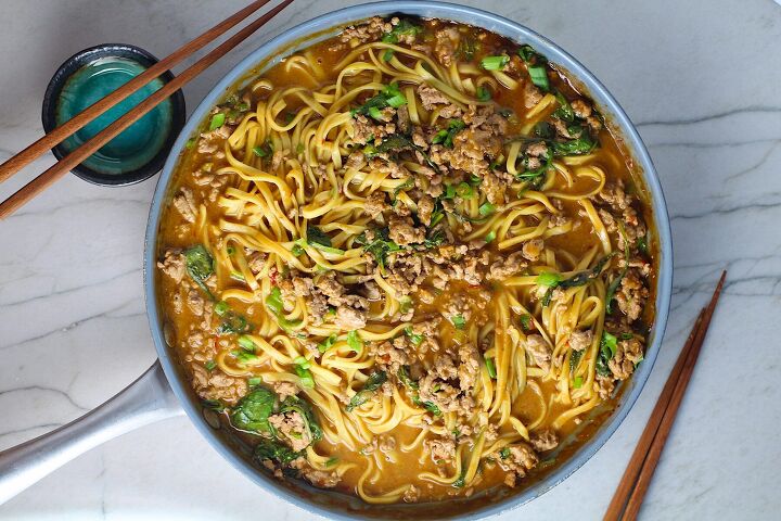 ground chicken dan dan noodles easy recipe, Dan Dan Noodle Recipe with Ground Chicken and scallions in a pan on counter with chopsticks next to it