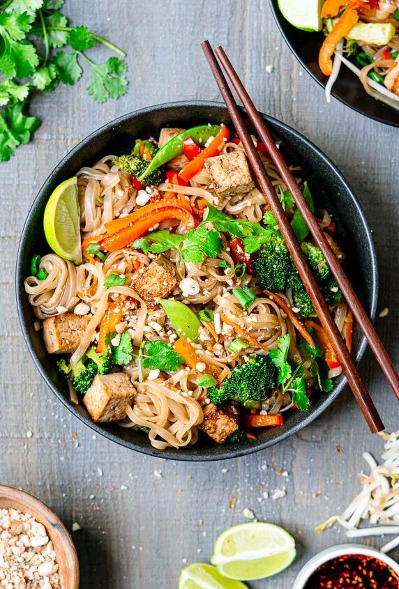 vegan pad thai with marinated tofu, vegetarian pad thai served with chopsticks garnished with cilantro and lime