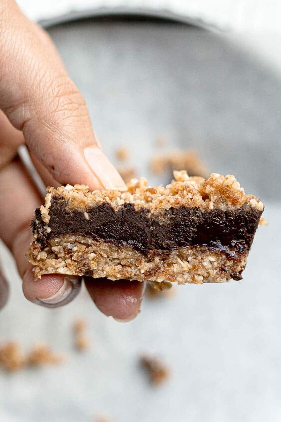 chocolate oat bars, hand holding chocolate oat bar with chocolate layer