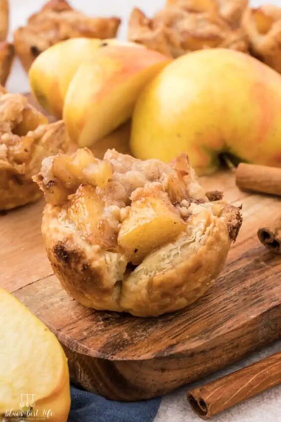 mini apple pie bites with puff pastry, A mini apple pie on a cutting board with an apple