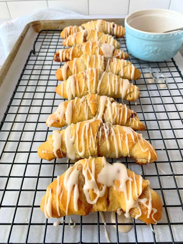 crescent roll cinnamon rolls, A cooling rack with crescent rolls on top and a bowl of icing