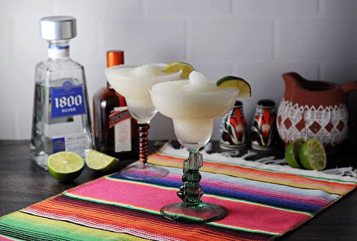 2 frozen margarita surrounded by ingredients