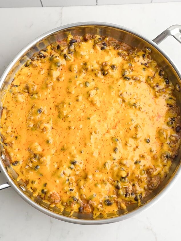 walking taco casserole with fritos, walking taco casserole with melted cheese in skillet