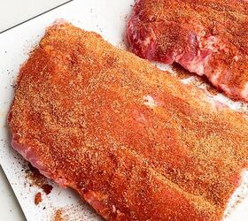 dr pepper crock pot ribs, two half racks of ribs with dry rub on a white cutting board