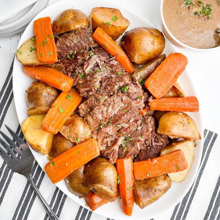 dr pepper crock pot ribs, pot roast with onion soup mix potatoes and carrots on a white platter
