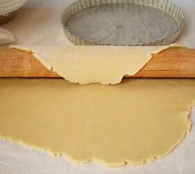 jam tart recipe bakewell tart with strawberry jam, Rolling out a pastry dough with a wood rolling pin