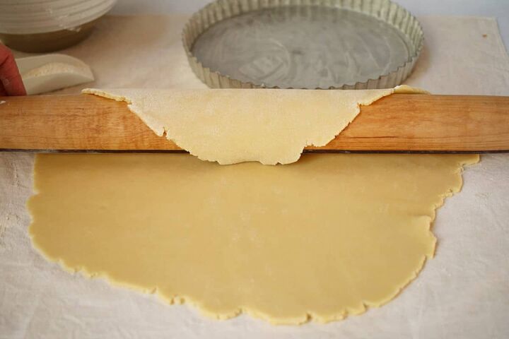 jam tart recipe bakewell tart with strawberry jam, Rolling out a pastry dough with a wood rolling pin