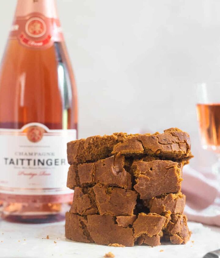 moist vegan banana pumpkin bread gf, Four pieces of vegan banana pumpkin bread stacked on top of each other with a bottle of Taittinger Rose in the background