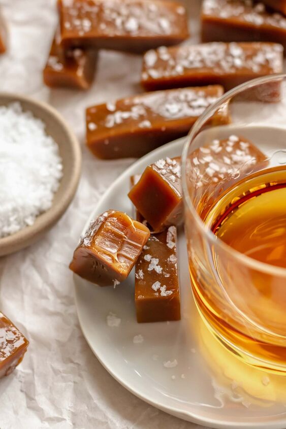 salted bourbon caramels, Salted caramels on a plate next to a glass of whiskey
