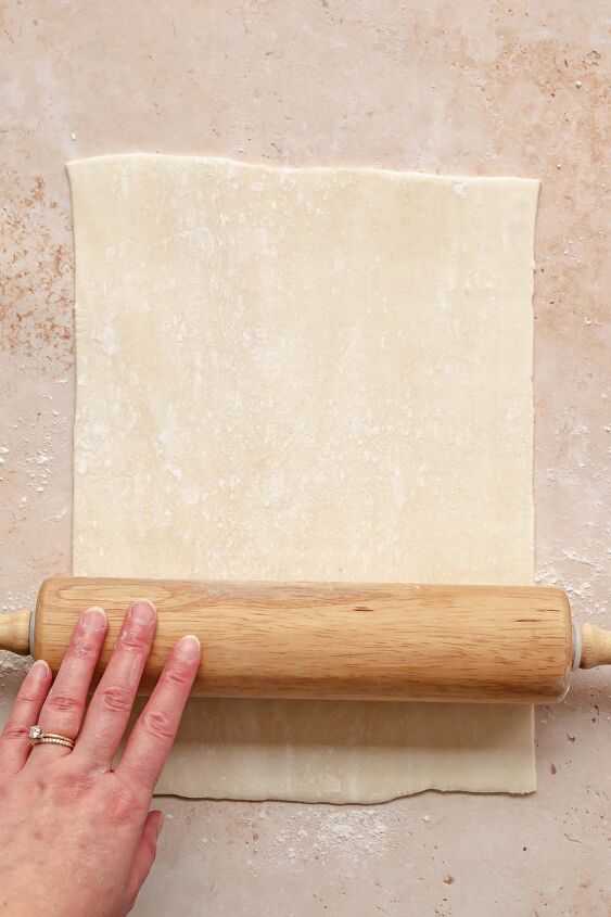 cream cheese cherry danish with puff pastry, A rolling pin rolls out puff pastry into a rectangle