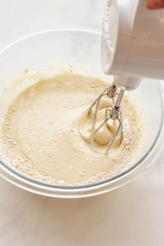 raspberry and almond cake, A hand mixer mixes in flour into cake batter