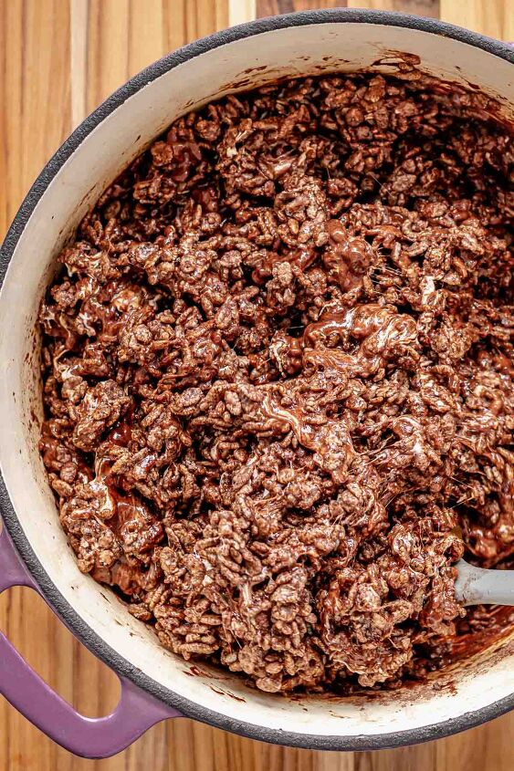 chocolate rice krispie treats, A spatula mixes cocoa Krispies into the marshmallow mixture in a pot