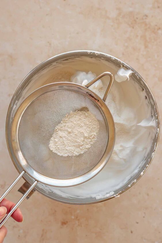 daffodil cake, Flour in a sifter going into a bowl of whipped egg whites