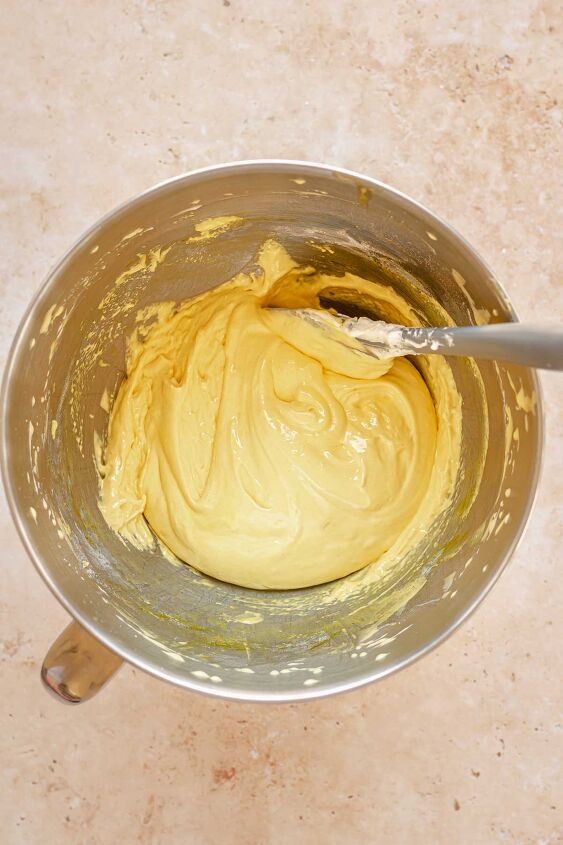 daffodil cake, A spatula folds flour into egg yolk batter in a bowl