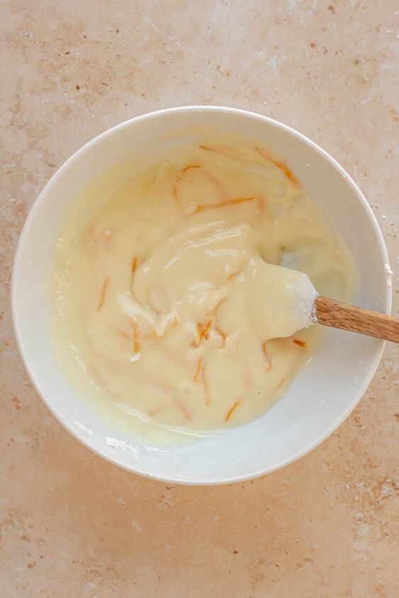 daffodil cake, Orange glaze ingredients mixed in a bowl