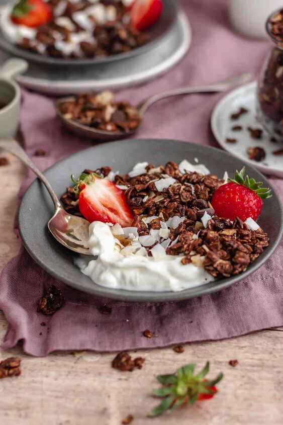 dark chocolate granola, Granola and yogurt in a bowl with a spoon and strawberries