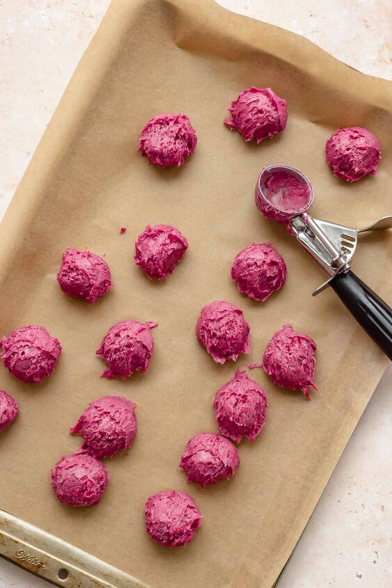 chocolate raspberry truffles with raspberry filling, Balls of raspberry truffles on a sheet pan with parchment paper